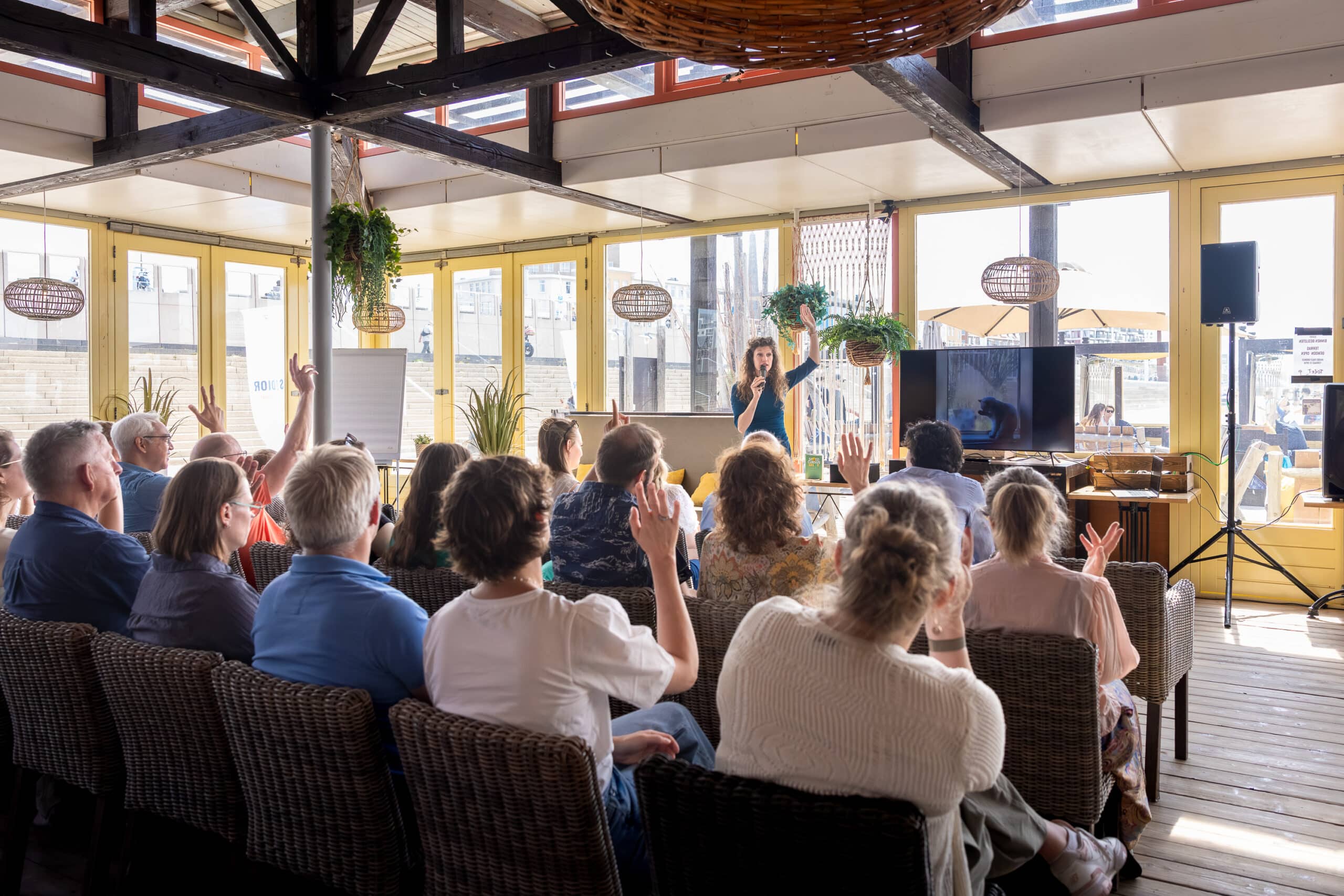 Vit-vrijdag presentatie collega's steken hun handen op als antwoord op een vraag